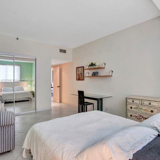 151 Crandon Boulevard, Unit 1130 Key Biscayne, FL 33149 - Photo 19 of 30 a bedroom with a bed and a large window