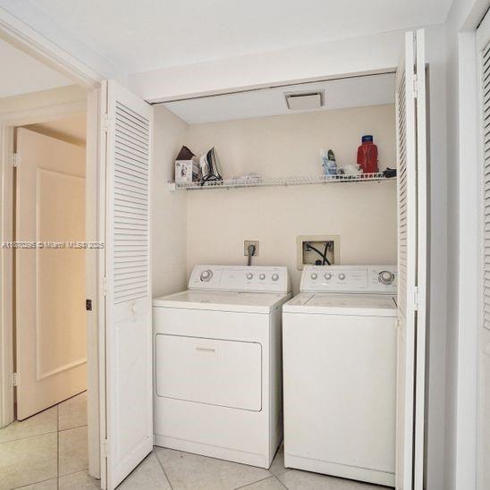 151 Crandon Boulevard, Unit 1130 Key Biscayne, FL 33149 - Photo 20 of 30 a view of storage and utility room with washer and dryer