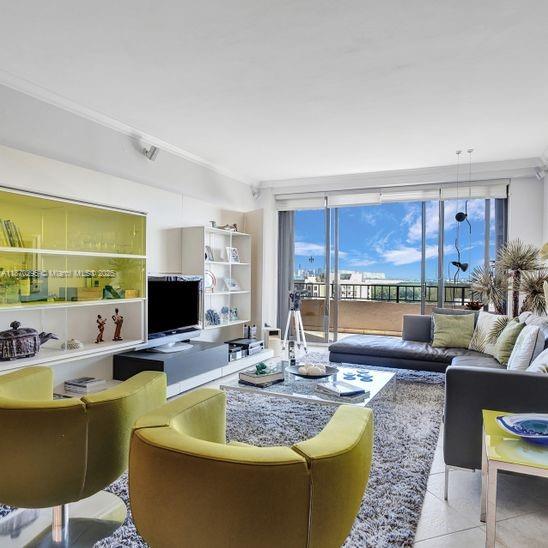 151 Crandon Boulevard, Unit 1130 Key Biscayne, FL 33149 - Photo 2 of 30 a living room with furniture and a flat screen tv