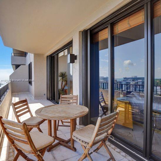 151 Crandon Boulevard, Unit 1130 Key Biscayne, FL 33149 - Photo 23 of 30 a view of a dining room with furniture wooden floor and a floor to ceiling window