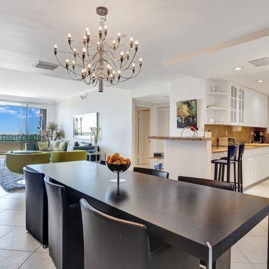 151 Crandon Boulevard, Unit 1130 Key Biscayne, FL 33149 - Photo 6 of 30 a view of a dining room with furniture and wooden floor