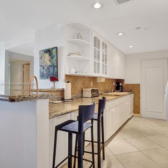 151 Crandon Boulevard, Unit 1130 Key Biscayne, FL 33149 - Photo 8 of 30 a kitchen with a sink and cabinets
