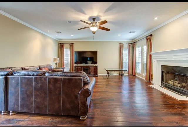 a living room with furniture a flat screen tv and a fireplace