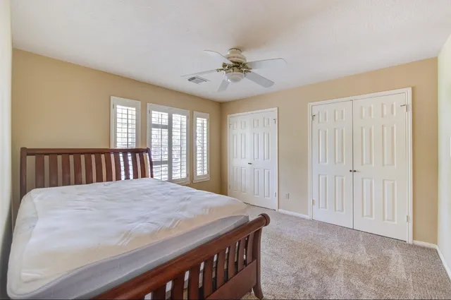 a bedroom with a bed and large window
