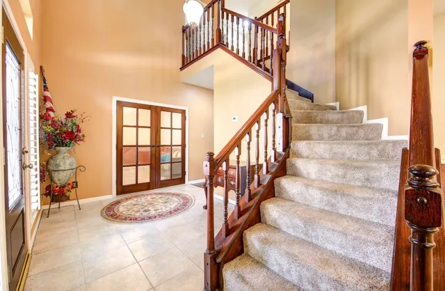 a view of entryway and hall with wooden floor