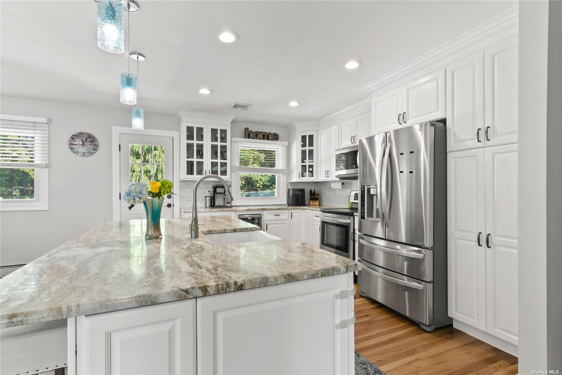 199 Ohls Street Patchogue, NY 11772 - Photo 1 of 1 a kitchen with stainless steel appliances granite countertop a refrigerator and a sink