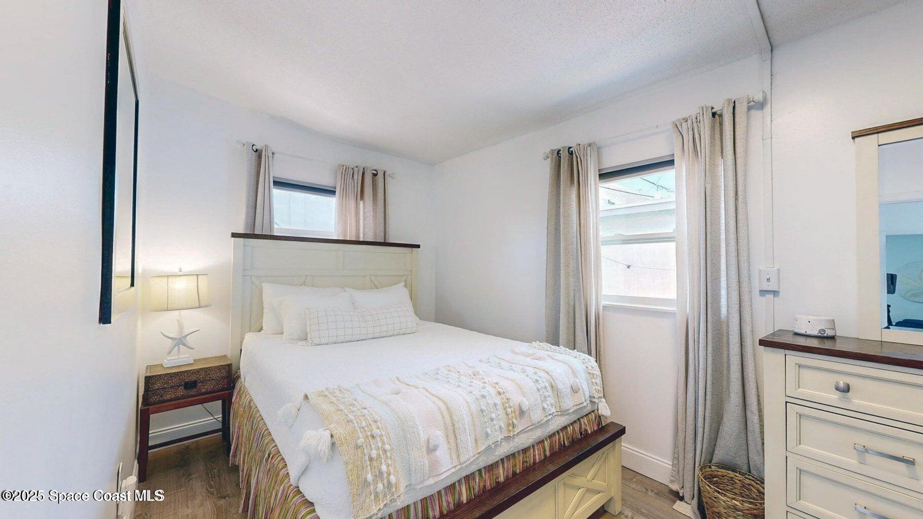 701 South Orlando Avenue, Unit C Cocoa Beach, FL 32931 - Photo 11 of 12 a bedroom with a bed and a window