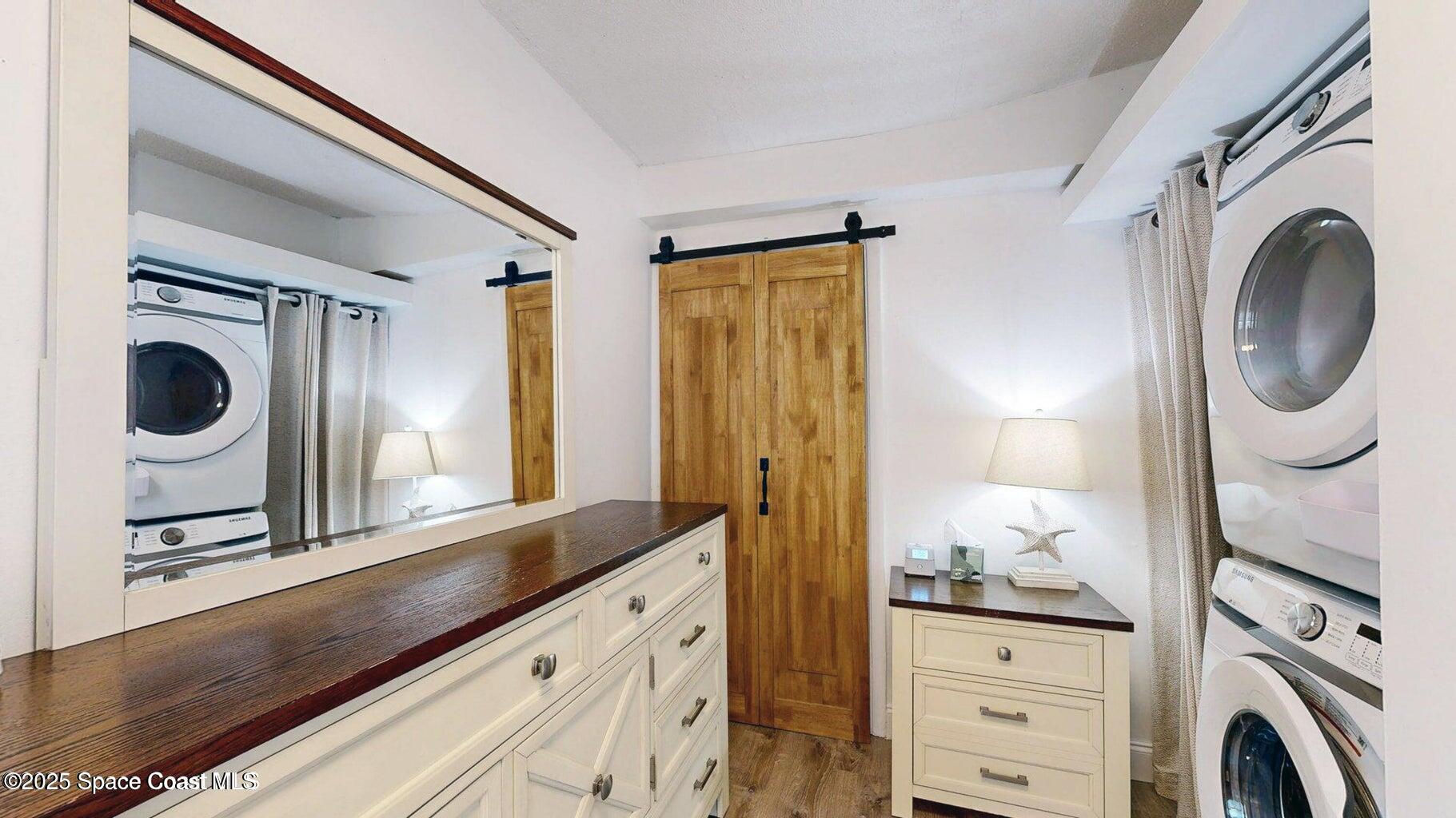 701 South Orlando Avenue, Unit C Cocoa Beach, FL 32931 - Photo 12 of 12 a bathroom with a sink a mirror and a shower curtain