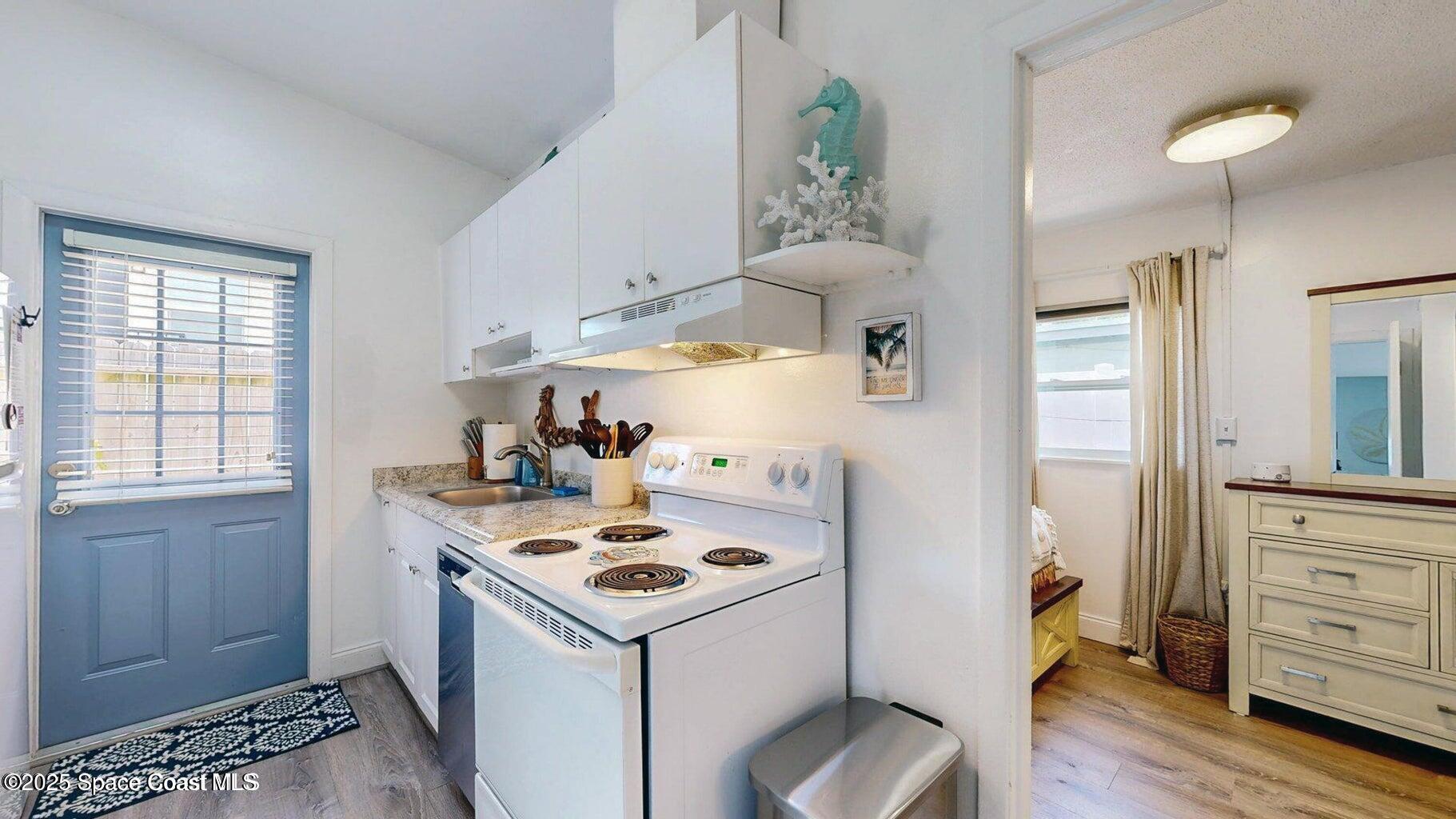701 South Orlando Avenue, Unit C Cocoa Beach, FL 32931 - Photo 3 of 12 a utility room with closet a stove and a window