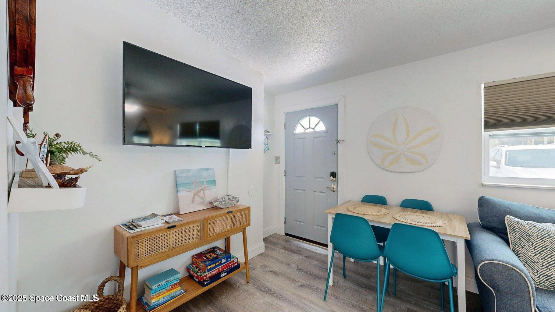 701 South Orlando Avenue, Unit C Cocoa Beach, FL 32931 - Photo 6 of 12 a living room with furniture and a flat screen tv