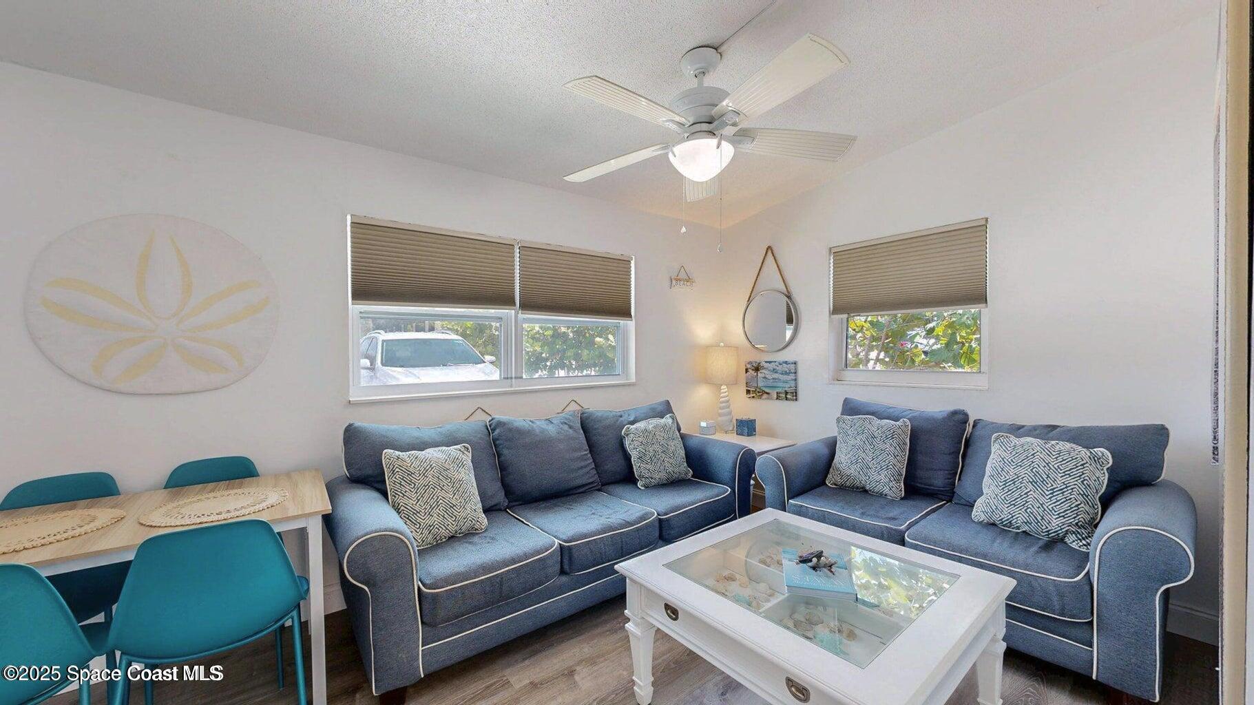 701 South Orlando Avenue, Unit C Cocoa Beach, FL 32931 - Photo 7 of 12 a living room with furniture and a window