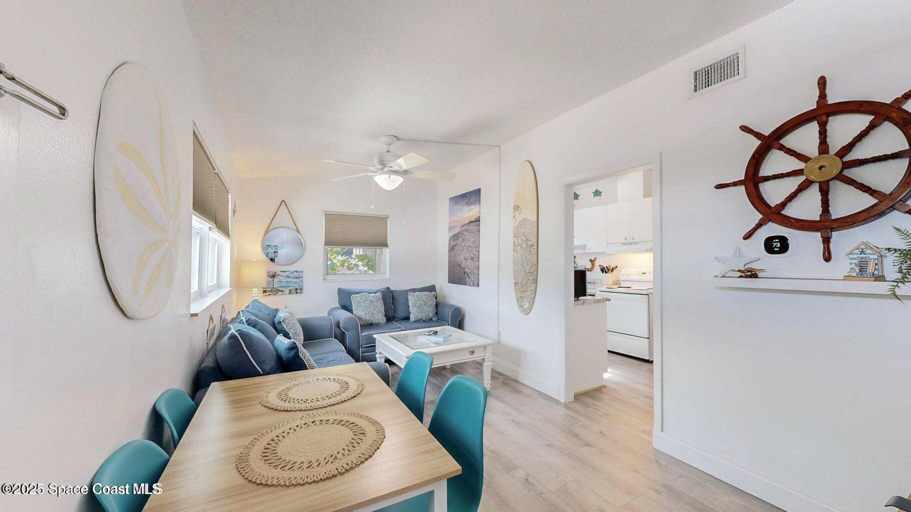 701 South Orlando Avenue, Unit C Cocoa Beach, FL 32931 - Photo 8 of 12 a living room with furniture a rug and white walls