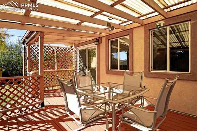 6723 Seneca Road Colorado Springs, CO 80915 - Photo 27 of 36 Sliding glass door from the main dining space opens to another relaxing space to enjoy with friends and family