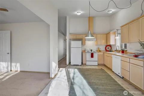 a kitchen with kitchen island a sink stainless steel appliances and cabinets