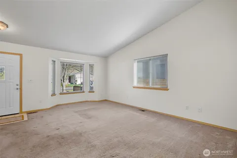 an empty room with windows and closet