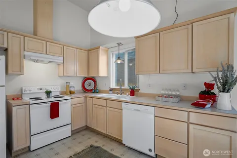a kitchen with white cabinets and white appliances