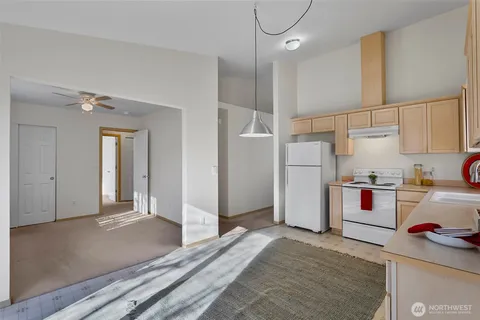 a kitchen with stainless steel appliances granite countertop a refrigerator and a stove top oven