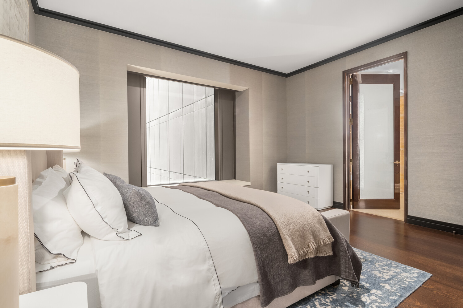 53 West 53rd Street, Unit 16E Manhattan, NY 10019 - Photo 4 of 7 a bedroom with a bed and wooden floor