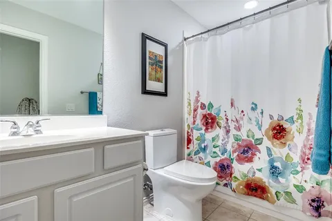 a bathroom with a sink mirror vanity and toilet