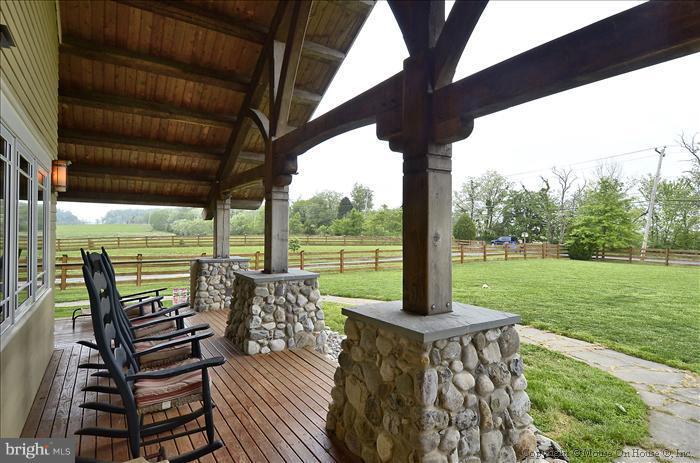 18340 Cattail Road Poolesville, MD 20837 - Photo 12 of 30 a view of a patio with a table chairs and a backyard