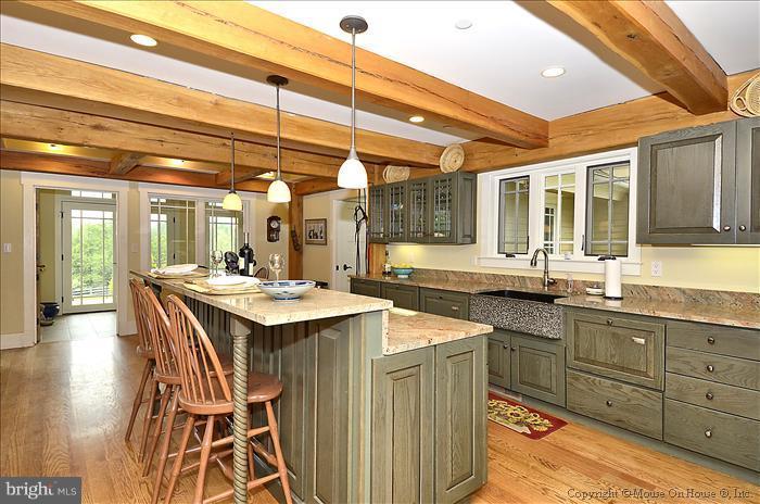 18340 Cattail Road Poolesville, MD 20837 - Photo 6 of 30 a kitchen with a sink and wooden cabinets