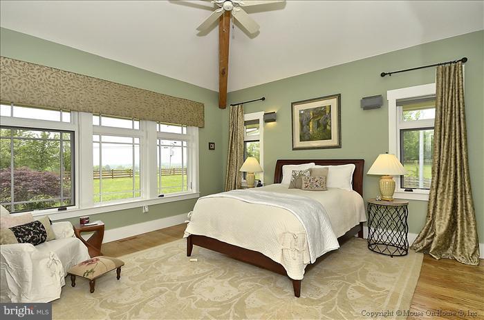 18340 Cattail Road Poolesville, MD 20837 - Photo 8 of 30 a spacious bedroom with a bed and a couch