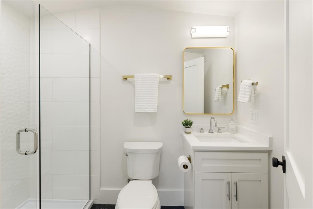 1124 Chestnut Street Newton, MA 02464 - Photo 27 of 41 a bathroom with a toilet sink and mirror