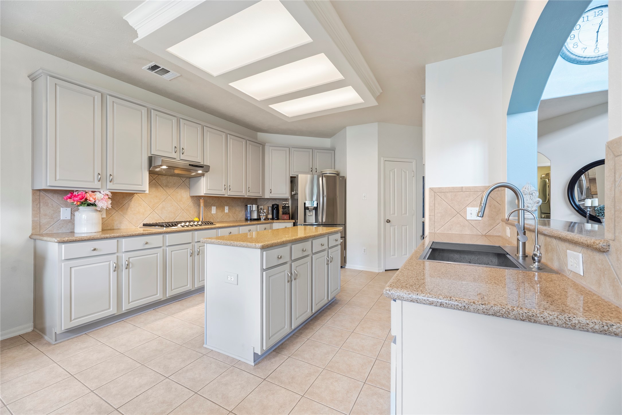 7930 Chateau Point Lane Houston, TX 77041 - Photo 12 of 34 This updated kitchen features modern cabinetry, sleek engineered quartz countertops, and stainless steel appliances. It includes a center island for plenty of functional cooking space.