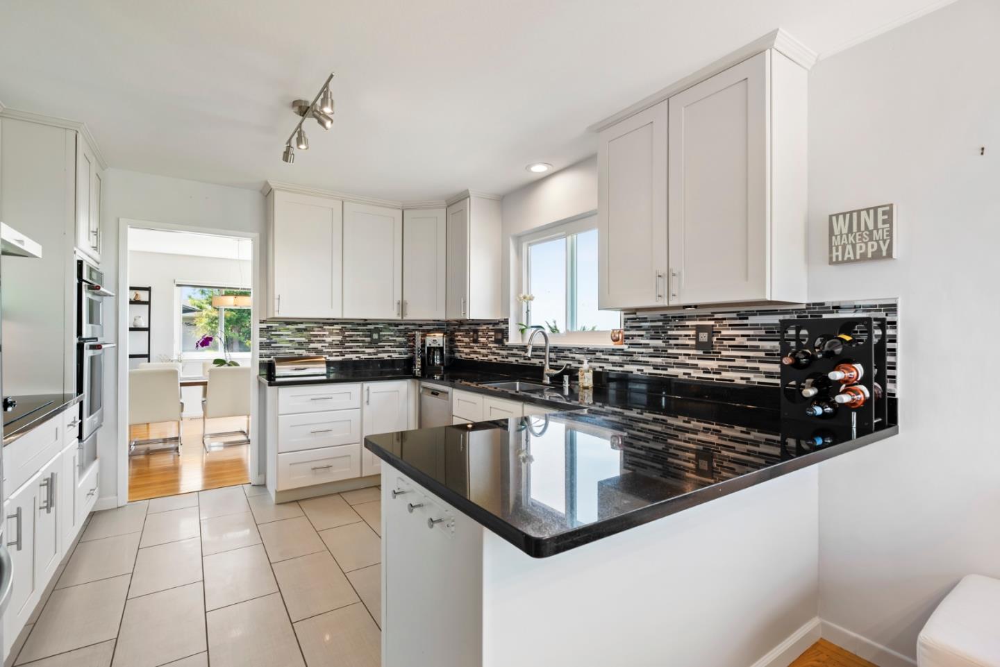 863 Viewridge Drive San Mateo, CA 94403 - Photo 15 of 50 a kitchen with a sink stove and refrigerator