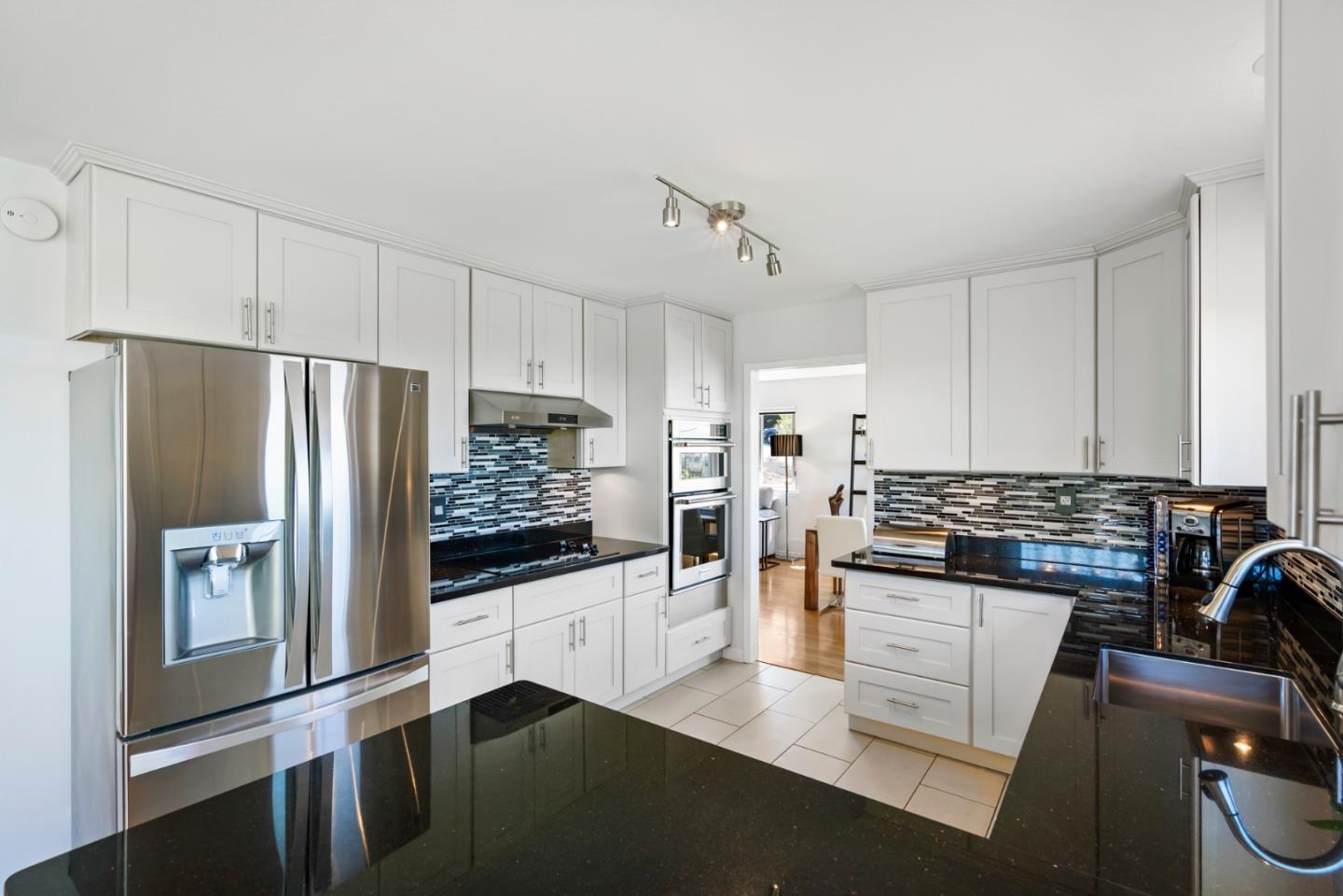 863 Viewridge Drive San Mateo, CA 94403 - Photo 16 of 50 a kitchen with stainless steel appliances a refrigerator a stove a sink and white cabinets