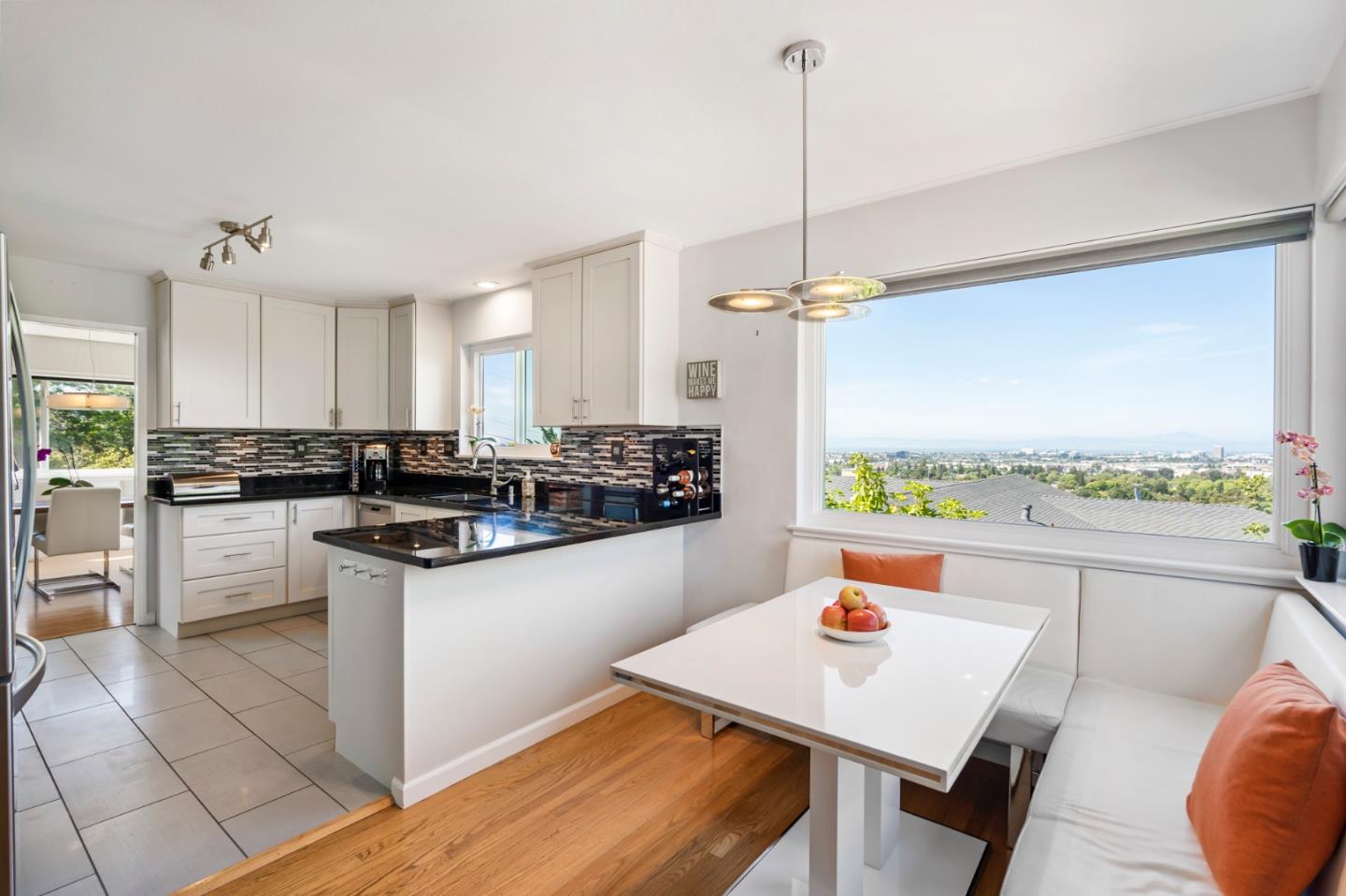 863 Viewridge Drive San Mateo, CA 94403 - Photo 18 of 50 a kitchen with stainless steel appliances granite countertop a stove a sink a refrigerator a microwave oven with a dining table and chairs