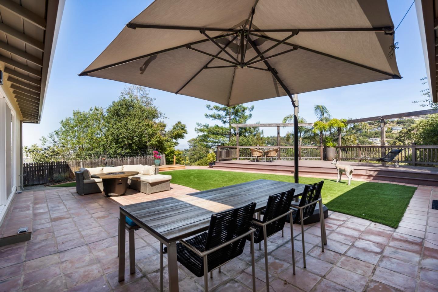 863 Viewridge Drive San Mateo, CA 94403 - Photo 26 of 50 a view of a patio with a table and chairs under an umbrella