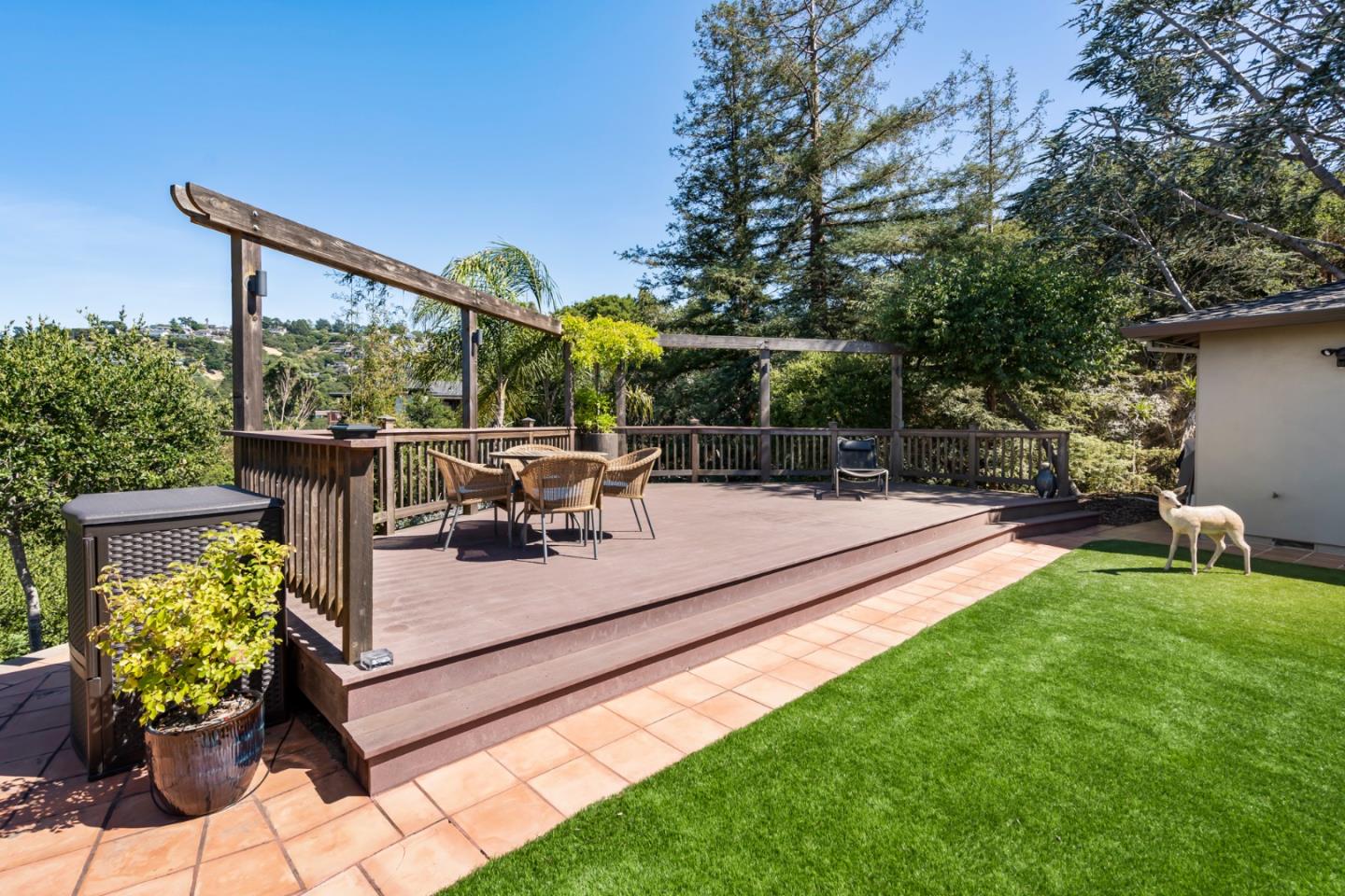 863 Viewridge Drive San Mateo, CA 94403 - Photo 28 of 50 a view of a patio with table and chairs potted plants and large tree