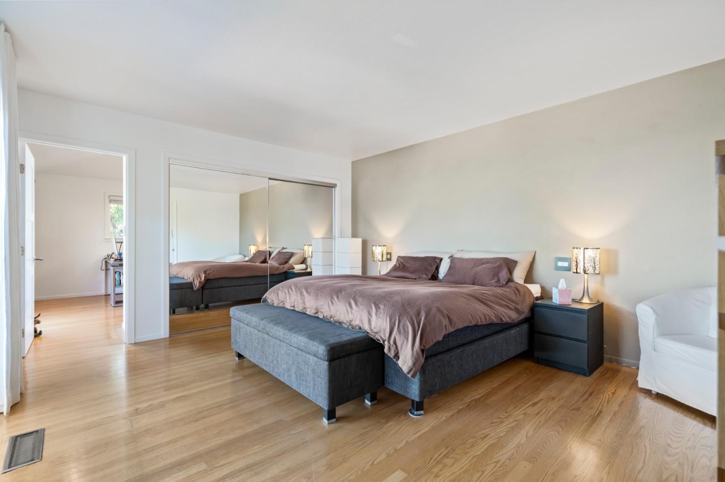 863 Viewridge Drive San Mateo, CA 94403 - Photo 31 of 50 a spacious bedroom with a bed and a couch