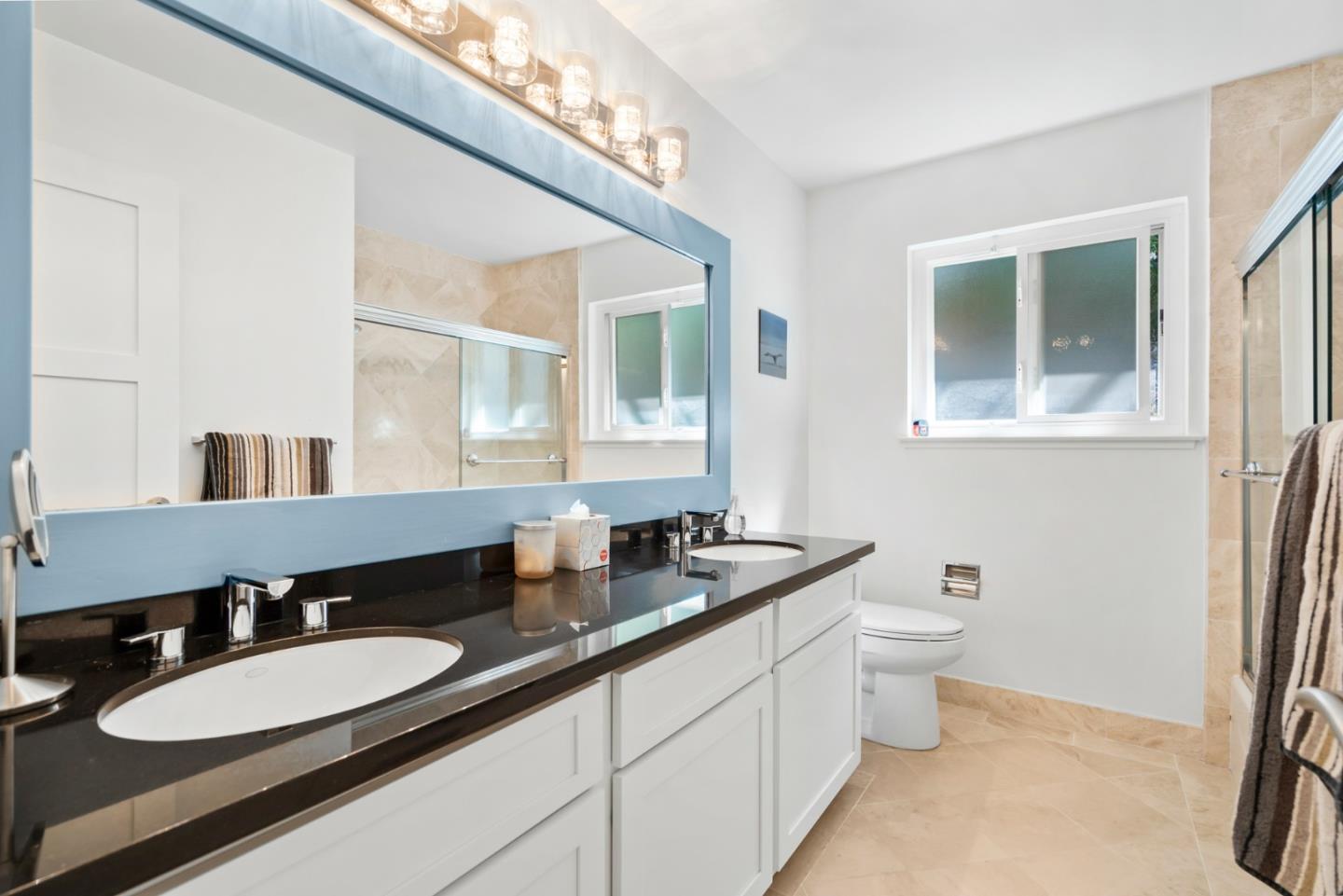 863 Viewridge Drive San Mateo, CA 94403 - Photo 42 of 50 a bathroom with a double vanity sink and a mirror