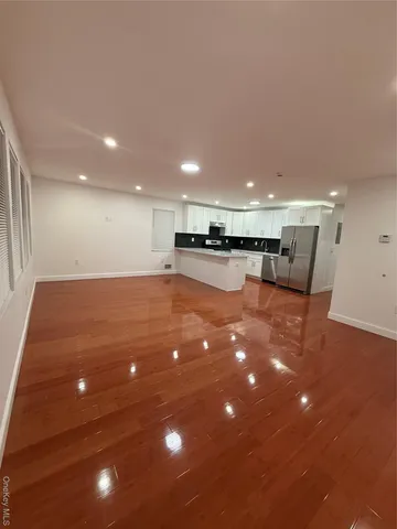 a kitchen with stainless steel appliances granite countertop a stove top oven a sink dishwasher and white cabinets