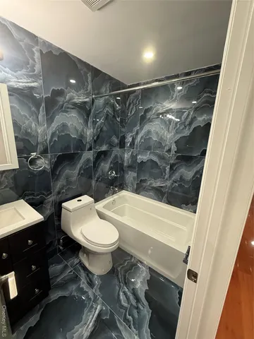 an empty room with wooden floor and windows in it