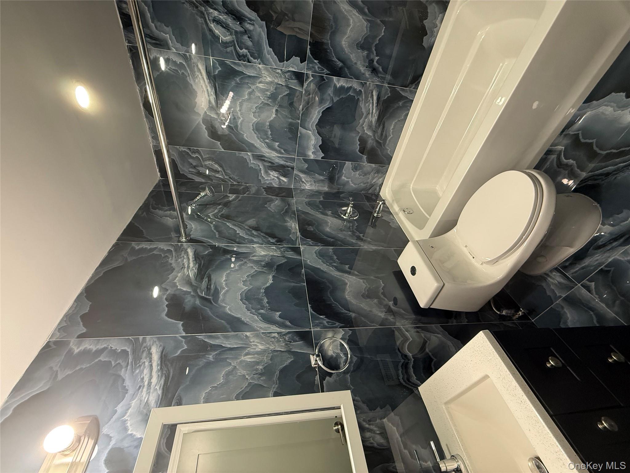 107-13 220th Street Queens, NY 11429 - Photo 9 of 10 a bathroom with a sink toilet and shower