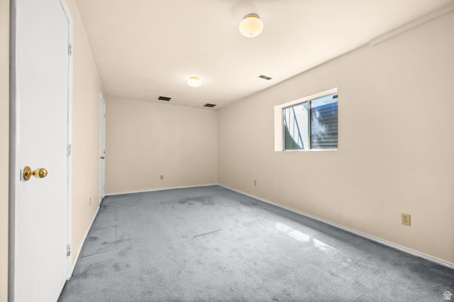 1650 Nichole Circle Sandy, UT 84093 - Photo 22 of 31 Room featuring light-colored walls and blue-gray carpeting
