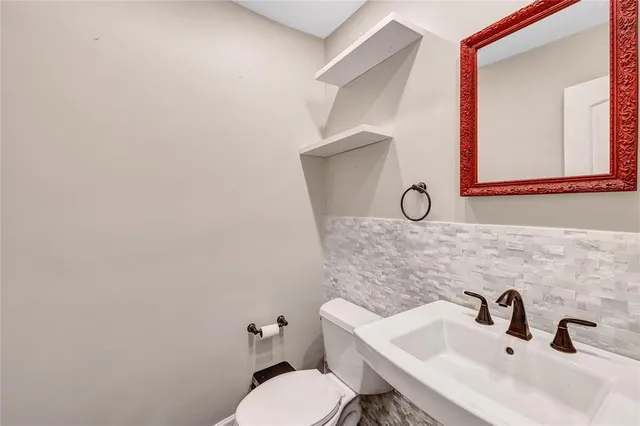 view of a hallway with wooden floor and a livingroom