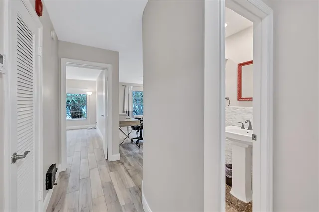 a view of an empty room with wooden floor