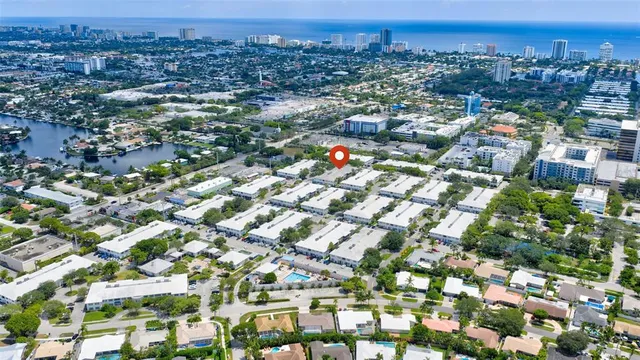 an aerial view of multiple houses with yard