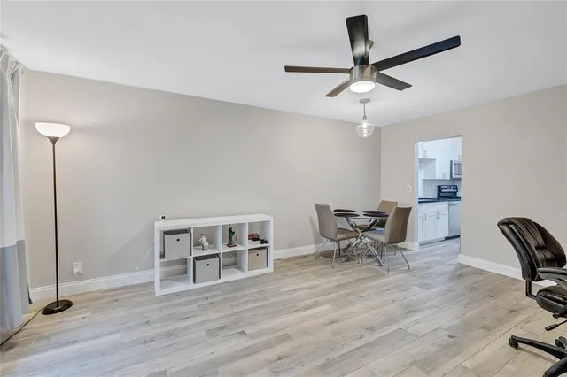 a view of a workspace with furniture and wooden floor