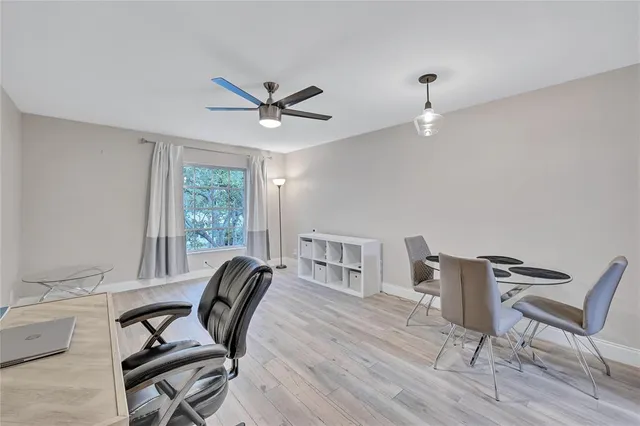 a view of a workspace with furniture and a window