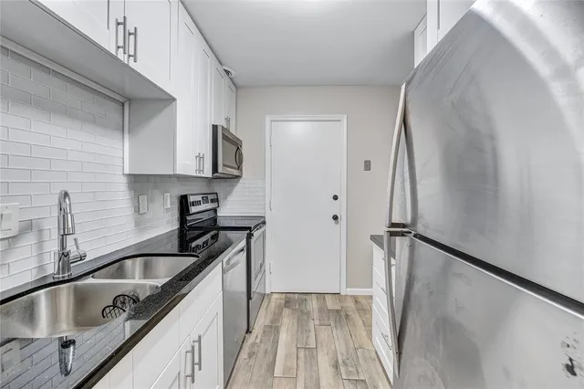 a kitchen with stainless steel appliances granite countertop a stove and a microwave