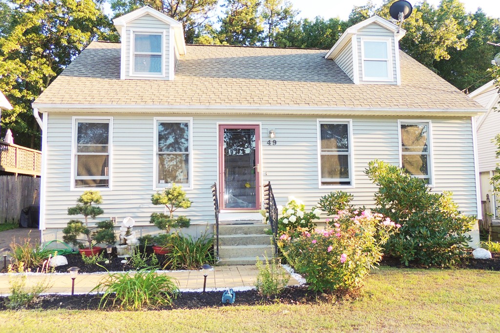 a front view of a house with garden