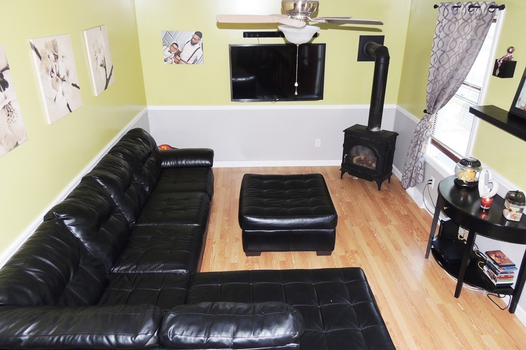 49 Wing Street Springfield, MA 01151 - Photo 6 of 19 a living room with furniture and a fireplace