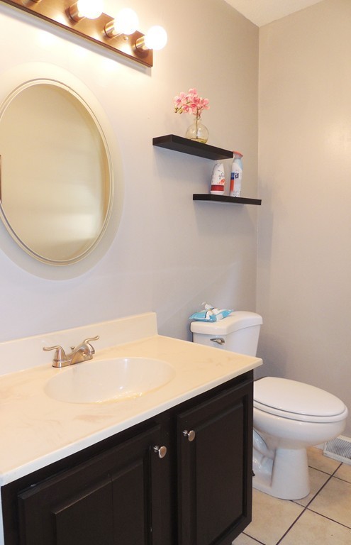49 Wing Street Springfield, MA 01151 - Photo 7 of 19 a bathroom with a sink a toilet and a mirror