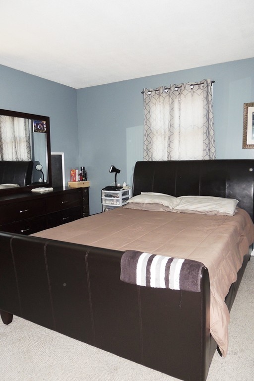 49 Wing Street Springfield, MA 01151 - Photo 8 of 19 a bedroom with a bed and a closet
