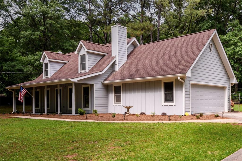 60 Valley Road Covington, GA 30016 - Photo 1 of 1 a front view of a house with a garden